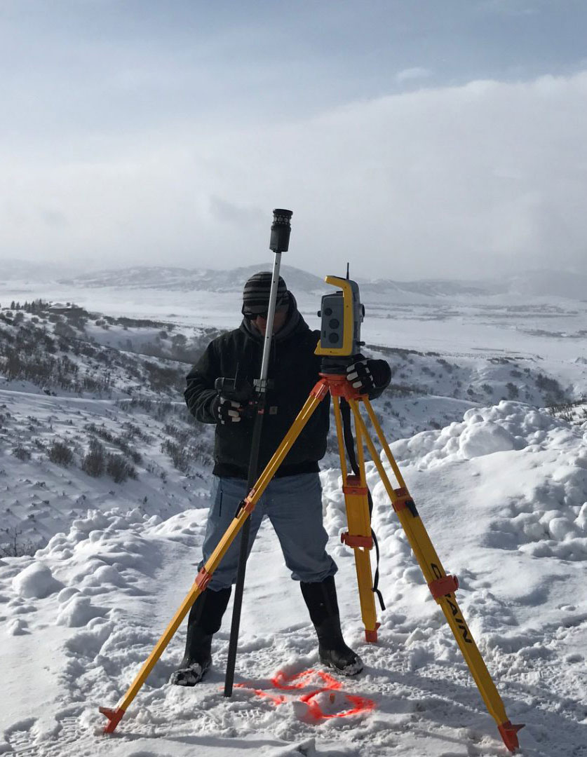 Surveying expert with Element Land Surveying setting up state of the art surveying equipment in Wasatch County